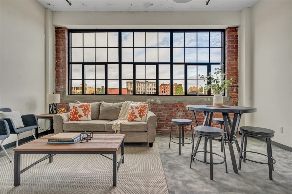 151 Chestnut Street, Unit 301 Springfield, MA 01103 - Photo 1 of 12 a living room with furniture and a window