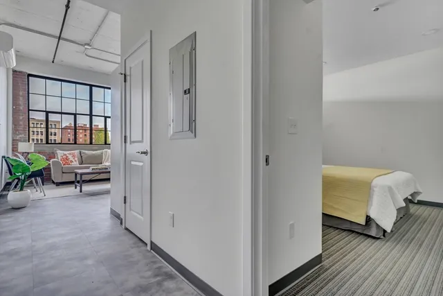 a view of a bedroom with closet and windows
