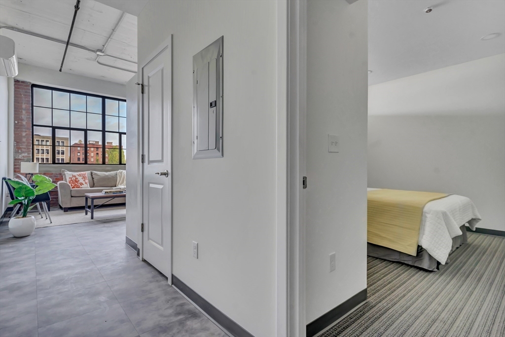 151 Chestnut Street, Unit 301 Springfield, MA 01103 - Photo 2 of 12 a view of a bedroom with closet and windows