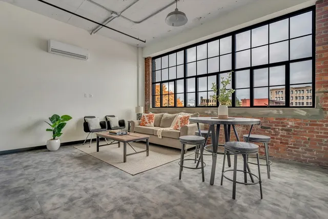 a reading room with furniture and a window