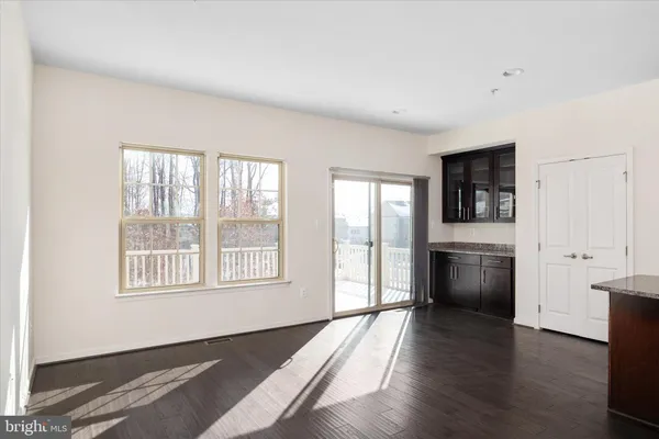 a kitchen with stainless steel appliances granite countertop a sink a stove and a wooden floors