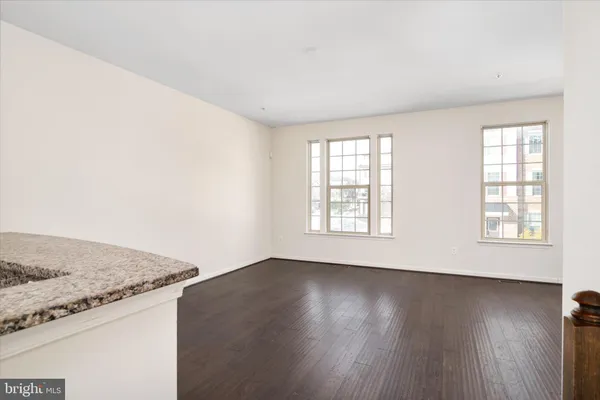 a kitchen with granite countertop a sink and cabinets