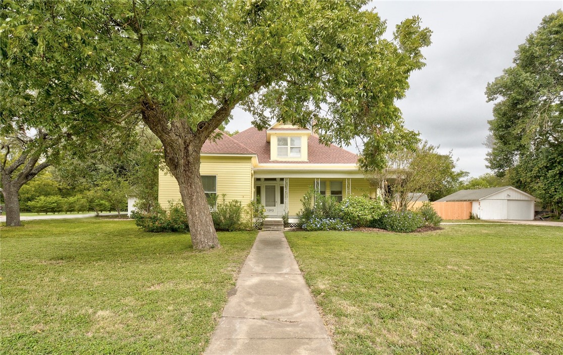 a front view of house with yard and green space