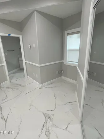 a bathroom with a shower sink and mirror
