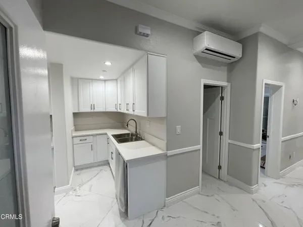 a kitchen with a sink cabinets and refrigerator