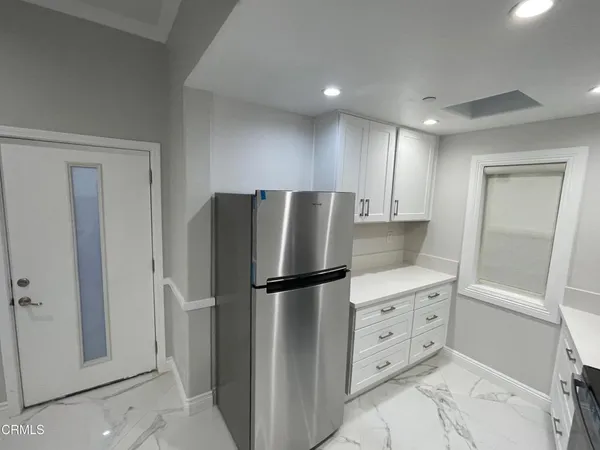 a kitchen with cabinets and stainless steel appliances