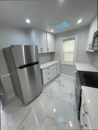 a kitchen with stainless steel appliances a refrigerator and a sink