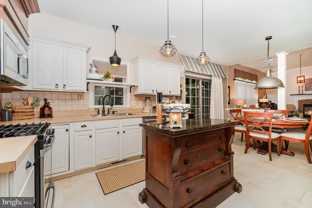 a kitchen with sink and cabinets