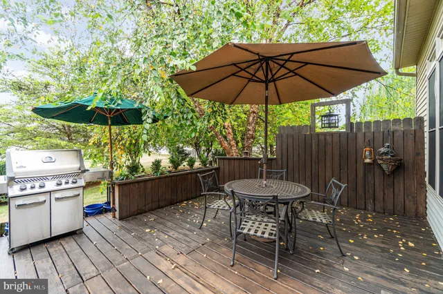 a view of house with yard and sitting area