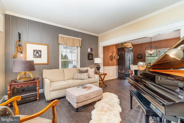 a living room with furniture and a piano