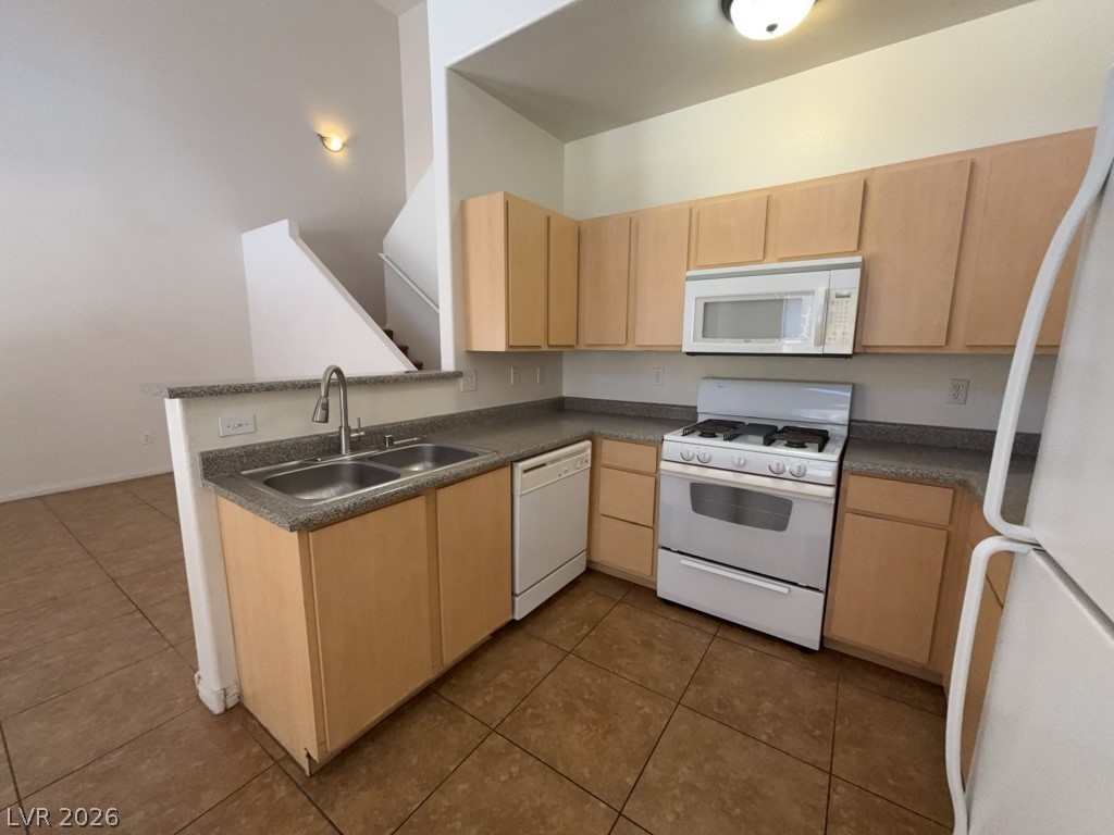 4915 East Russell Road, Unit 180 Las Vegas, NV 89120 - Photo 2 of 8 This functional kitchen features a practical layout with durable surfaces and a seamless connection to the living area.