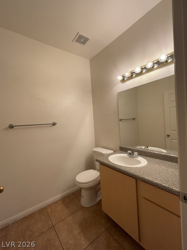 4915 East Russell Road, Unit 180 Las Vegas, NV 89120 - Photo 7 of 8 This bathroom features a simple vanity, toilet, and tiled flooring, perfect for everyday use.