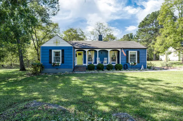a front view of a house with a garden
