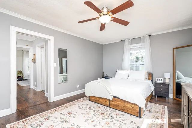 a bedroom with a large bed and a chandelier