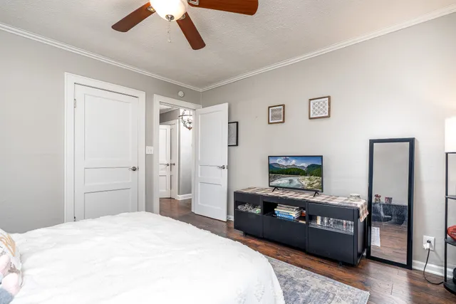 a bedroom with a bed and a chandelier