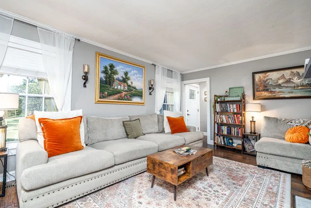 a living room with furniture and a book shelf