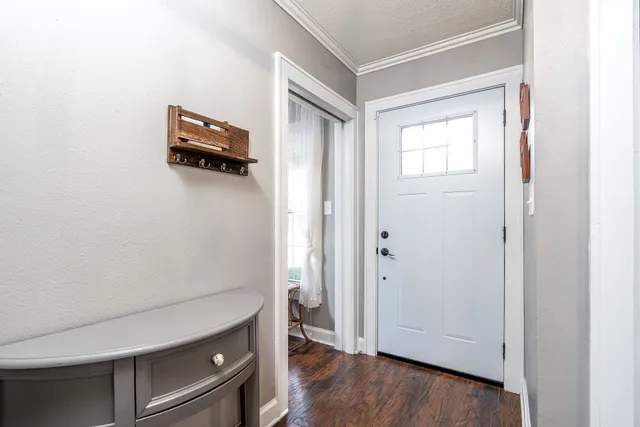 a room with a wooden floor and a window