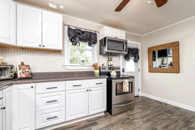 a kitchen with stainless steel appliances granite countertop a sink and a stove