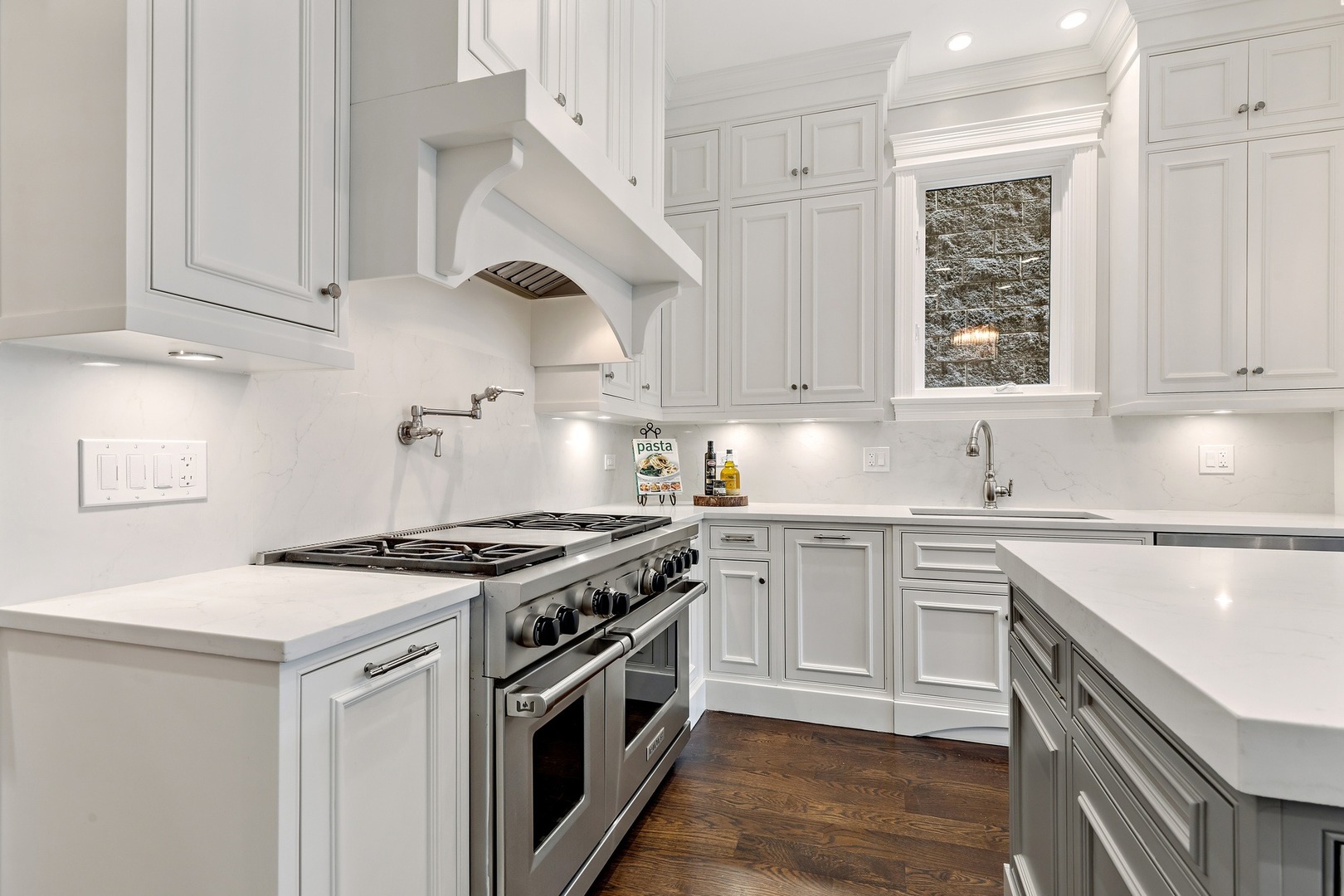 1445 West Wolfram Street Chicago, IL 60657 - Photo 13 of 69 a kitchen with granite countertop white cabinets and stainless steel appliances
