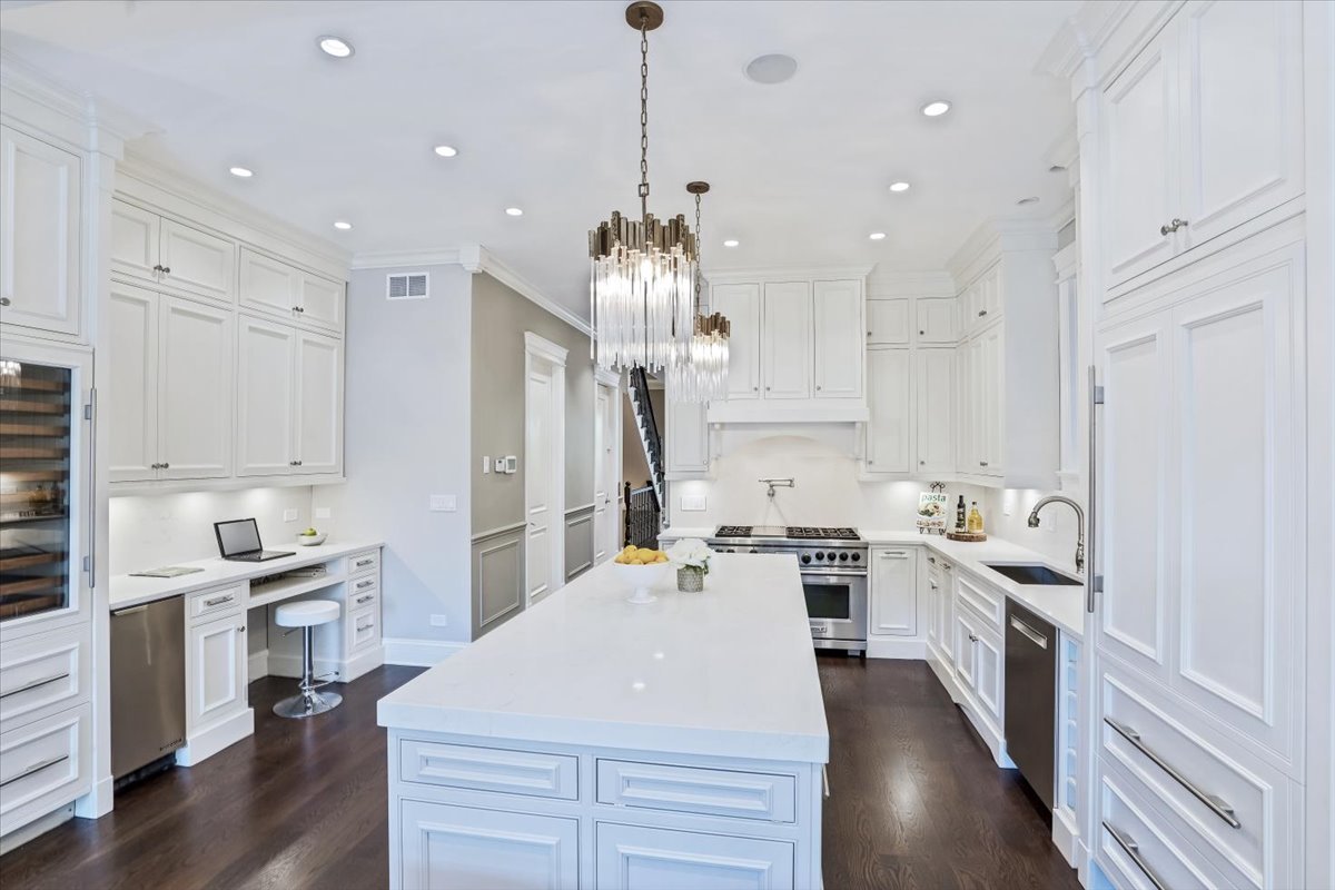 1445 West Wolfram Street Chicago, IL 60657 - Photo 16 of 69 a kitchen with kitchen island a sink stainless steel appliances and cabinets