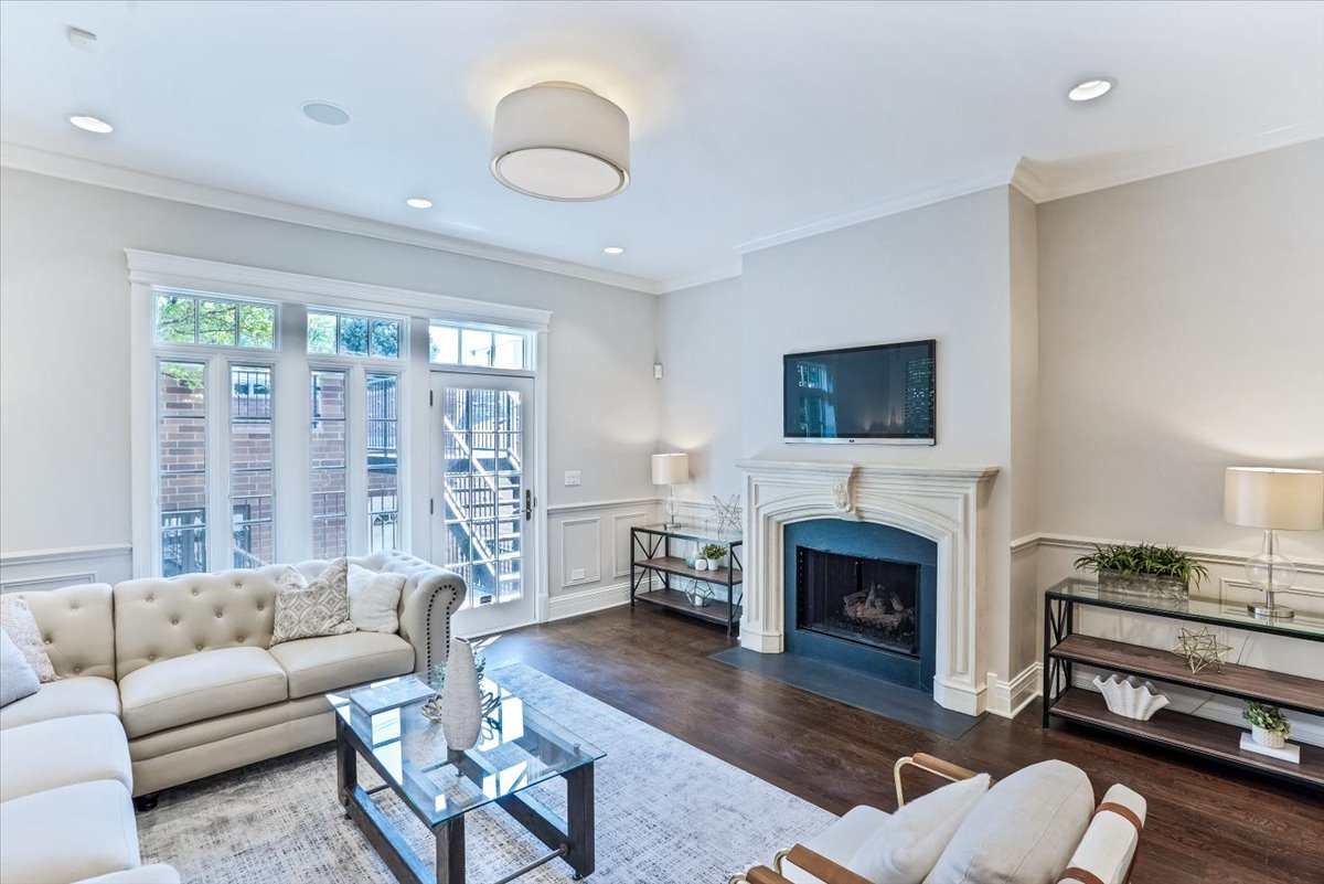 1445 West Wolfram Street Chicago, IL 60657 - Photo 24 of 69 a living room with furniture a fireplace a flat screen tv and a fireplace