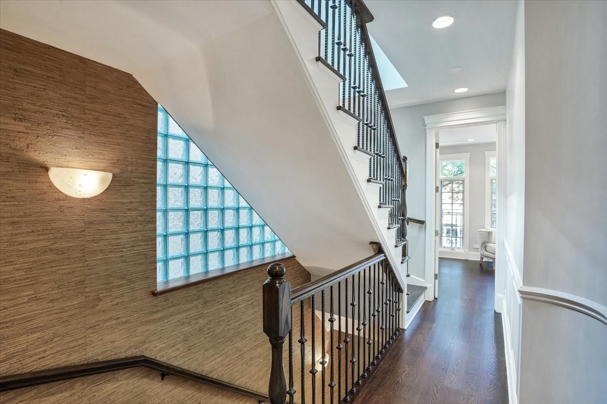 1445 West Wolfram Street Chicago, IL 60657 - Photo 26 of 69 a view of staircase with lots of frames on wall and a window
