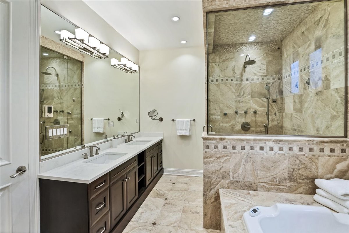1445 West Wolfram Street Chicago, IL 60657 - Photo 32 of 69 a spacious bathroom with a granite countertop sink a toilet a mirror and shower