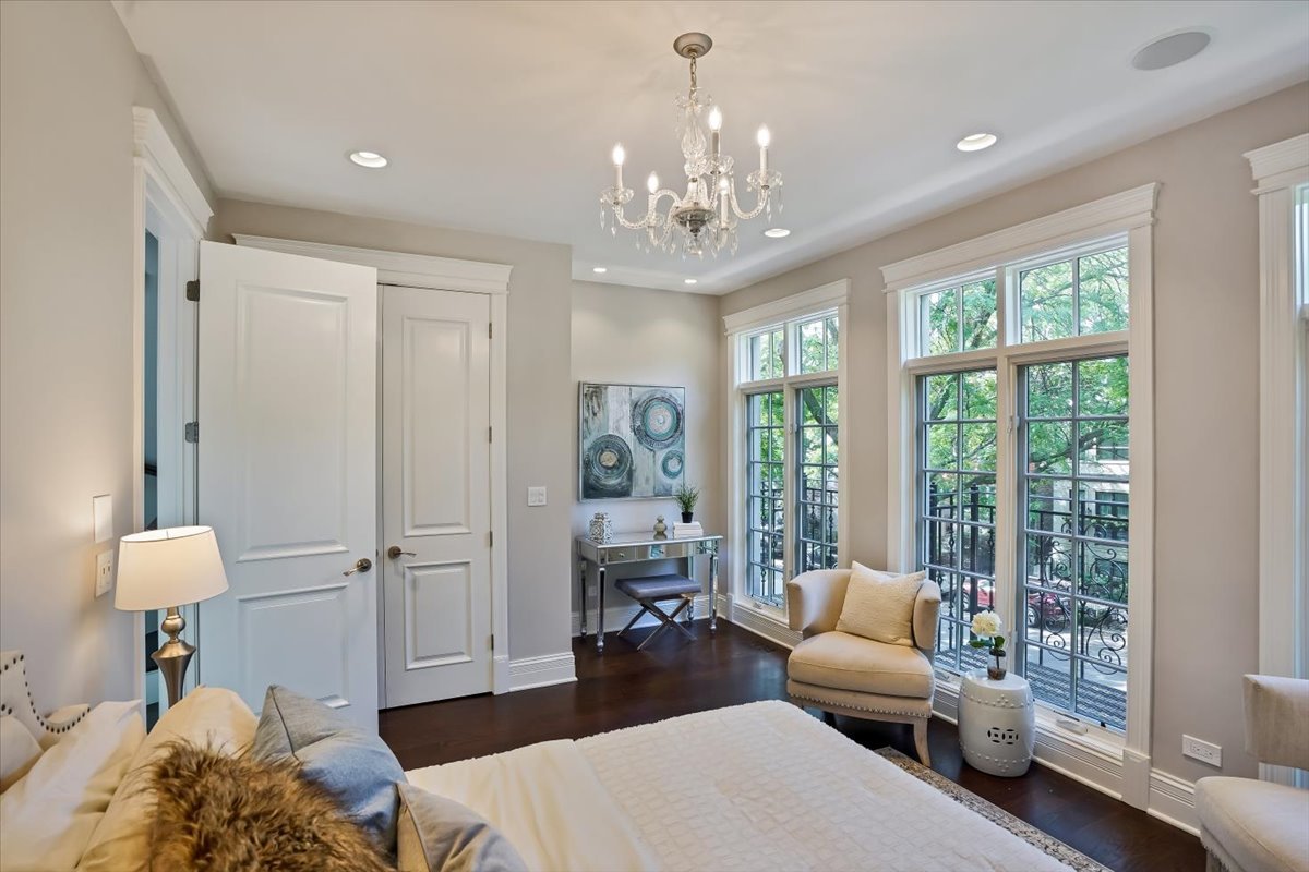 1445 West Wolfram Street Chicago, IL 60657 - Photo 33 of 69 a spacious bedroom with a bed and a chandelier