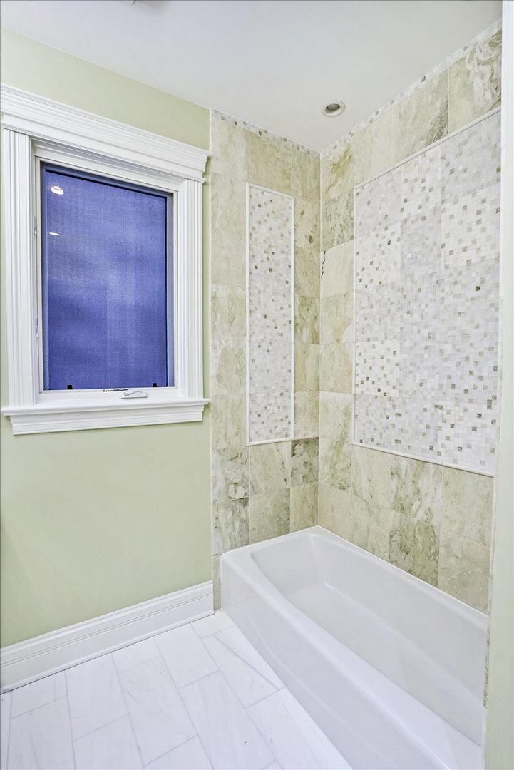 1445 West Wolfram Street Chicago, IL 60657 - Photo 36 of 69 a bathroom with a bathtub and shower