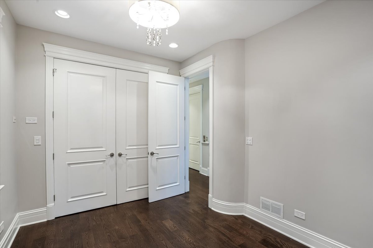 1445 West Wolfram Street Chicago, IL 60657 - Photo 37 of 69 a view of an empty room with wooden floor