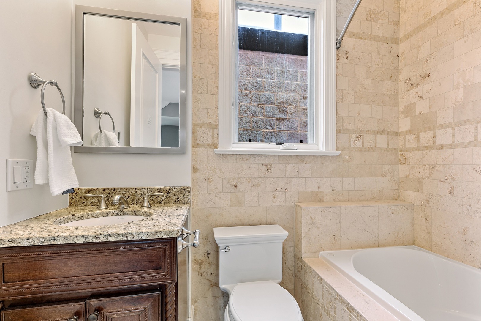 1445 West Wolfram Street Chicago, IL 60657 - Photo 42 of 69 a bathroom with a granite countertop toilet sink and mirror