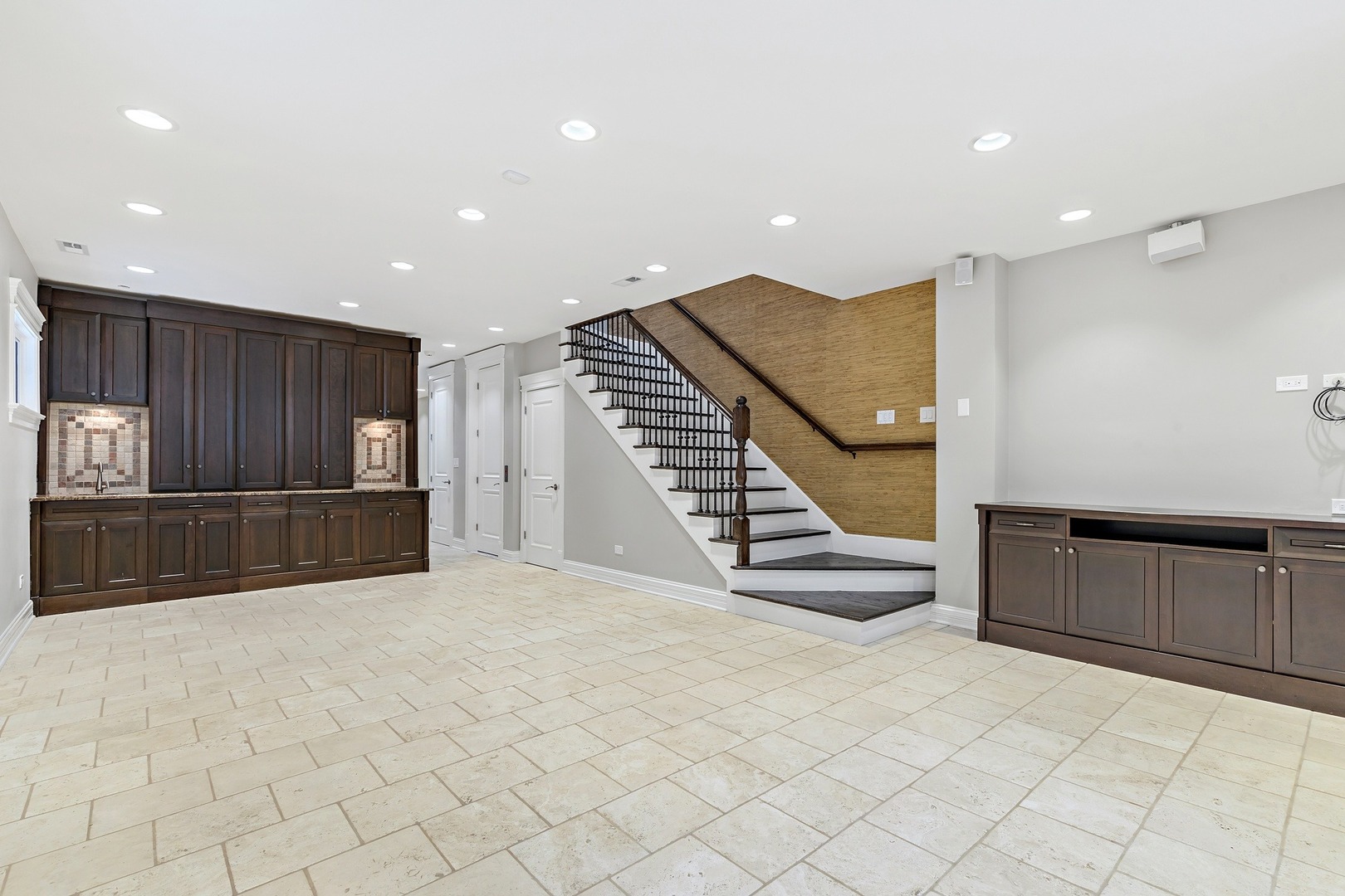 1445 West Wolfram Street Chicago, IL 60657 - Photo 47 of 69 a view of an empty room with kitchen and stairs