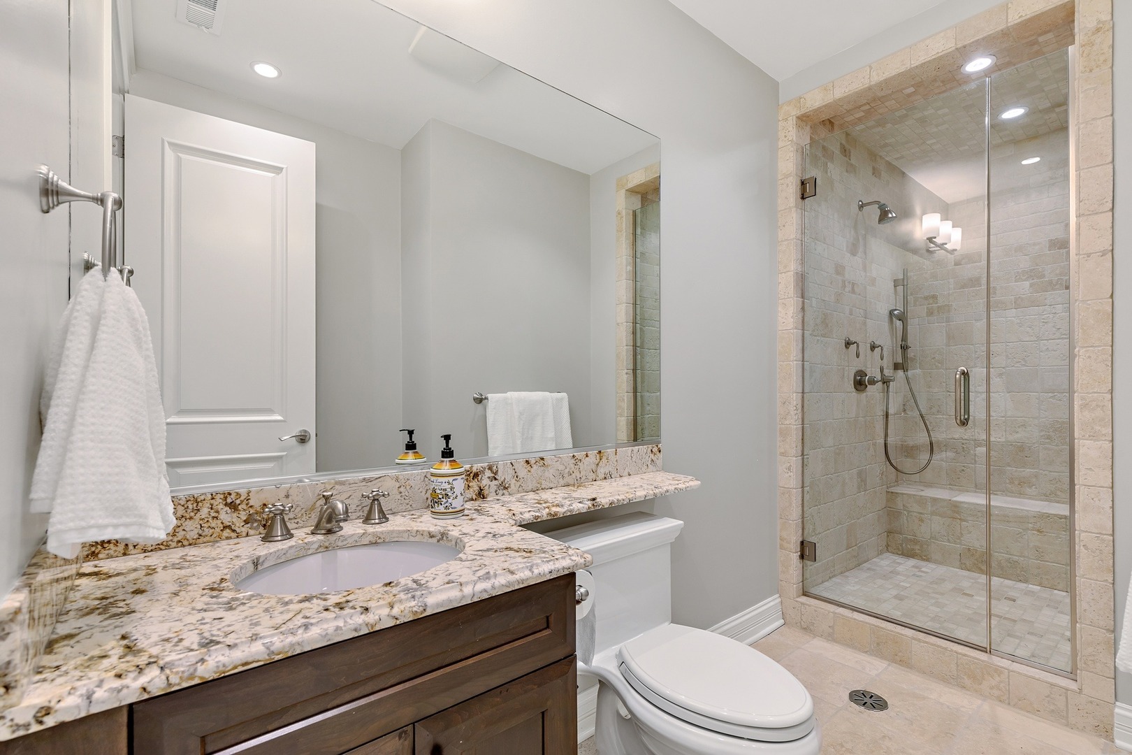 1445 West Wolfram Street Chicago, IL 60657 - Photo 49 of 69 a bathroom with a granite countertop sink toilet mirror and shower