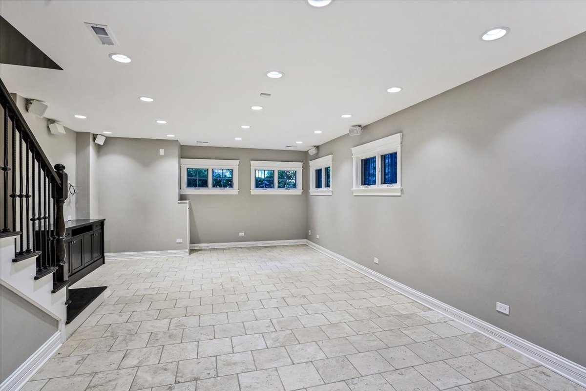 1445 West Wolfram Street Chicago, IL 60657 - Photo 56 of 69 a view of an empty room with wooden floor and staircase