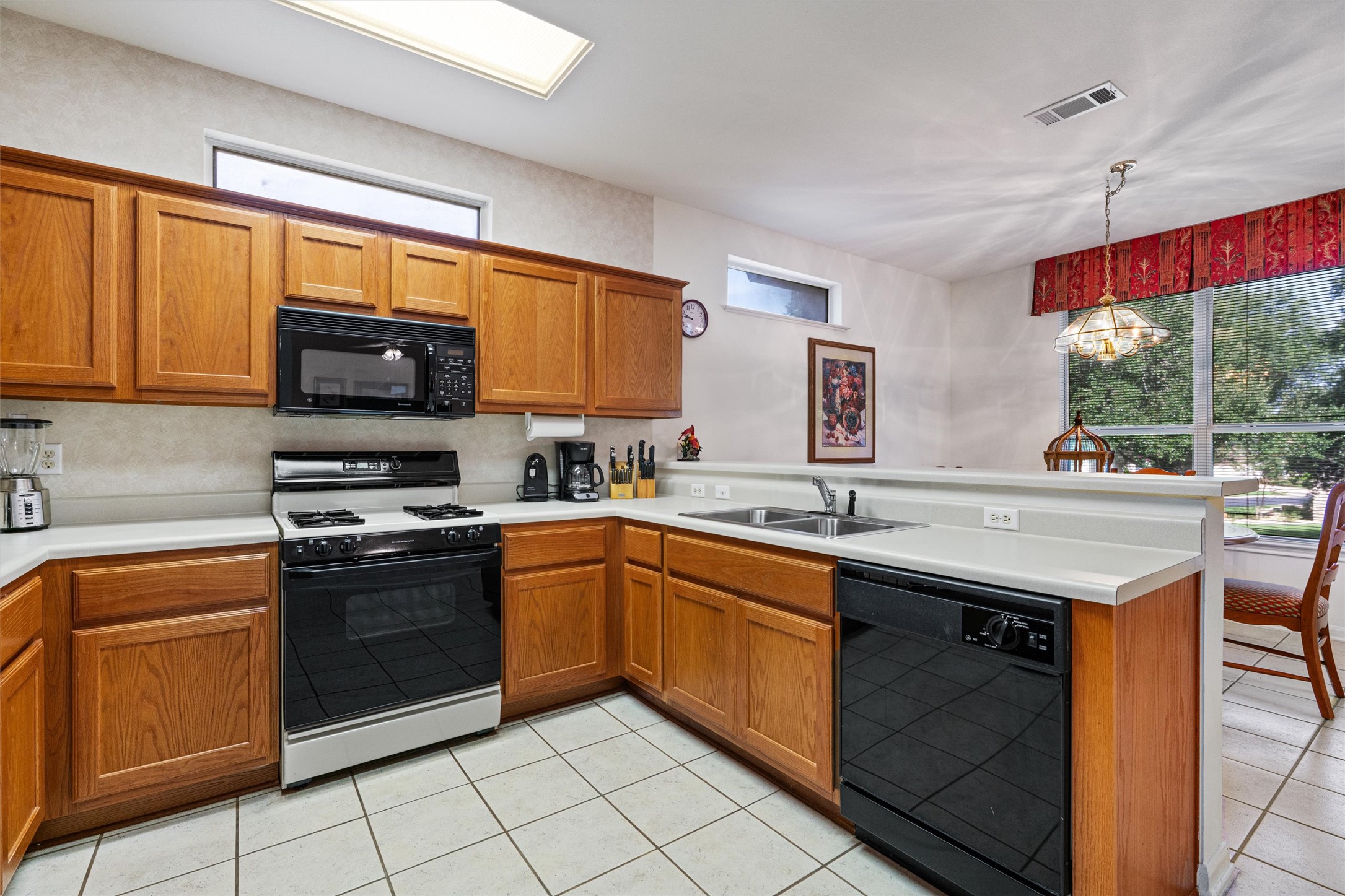 121 Larkspur Lane Georgetown, TX 78633 - Photo 8 of 28 a kitchen with stainless steel appliances granite countertop stove top oven a sink dishwasher and cabinets