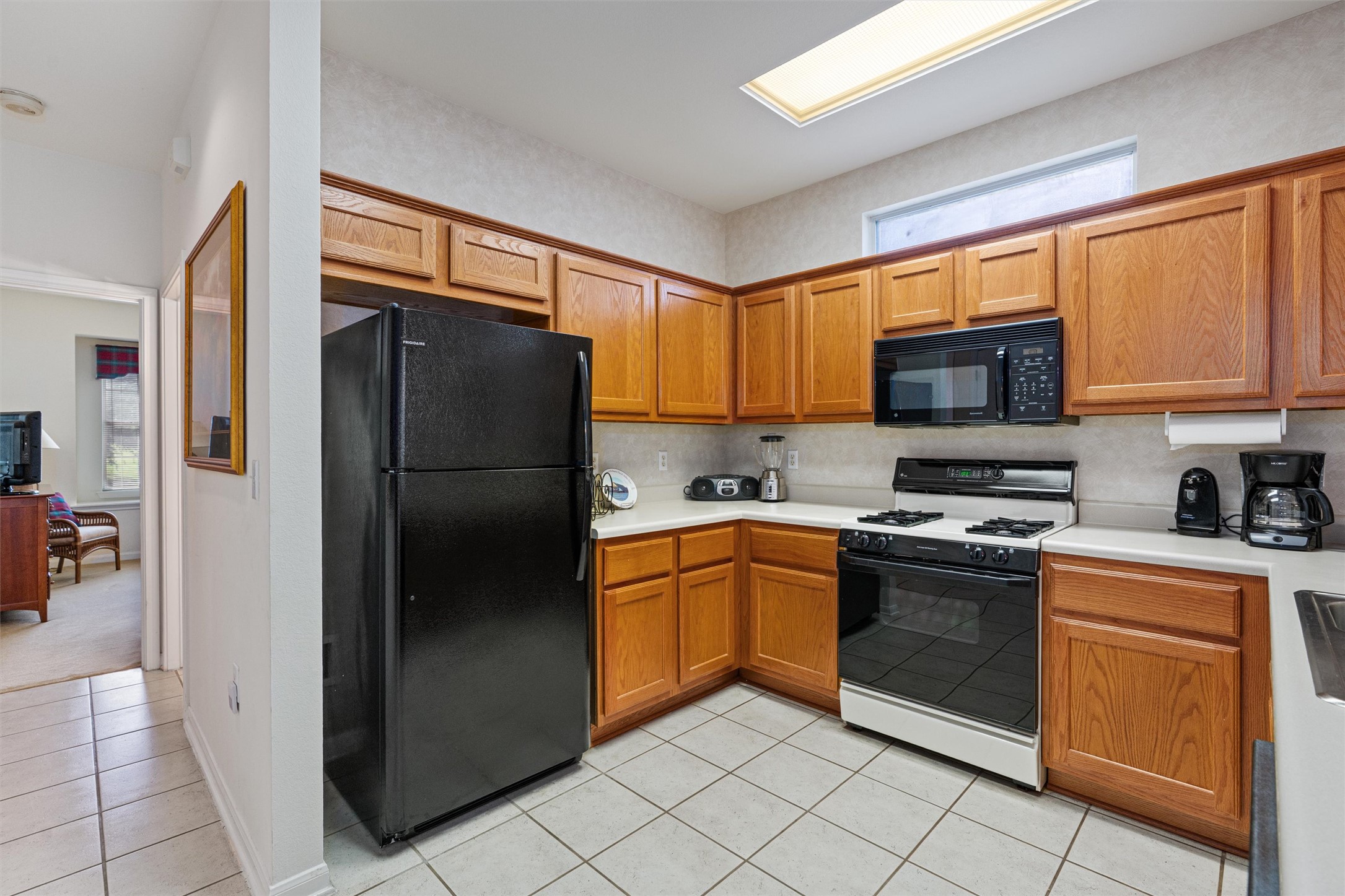 121 Larkspur Lane Georgetown, TX 78633 - Photo 9 of 28 a kitchen with stainless steel appliances granite countertop a refrigerator stove and microwave