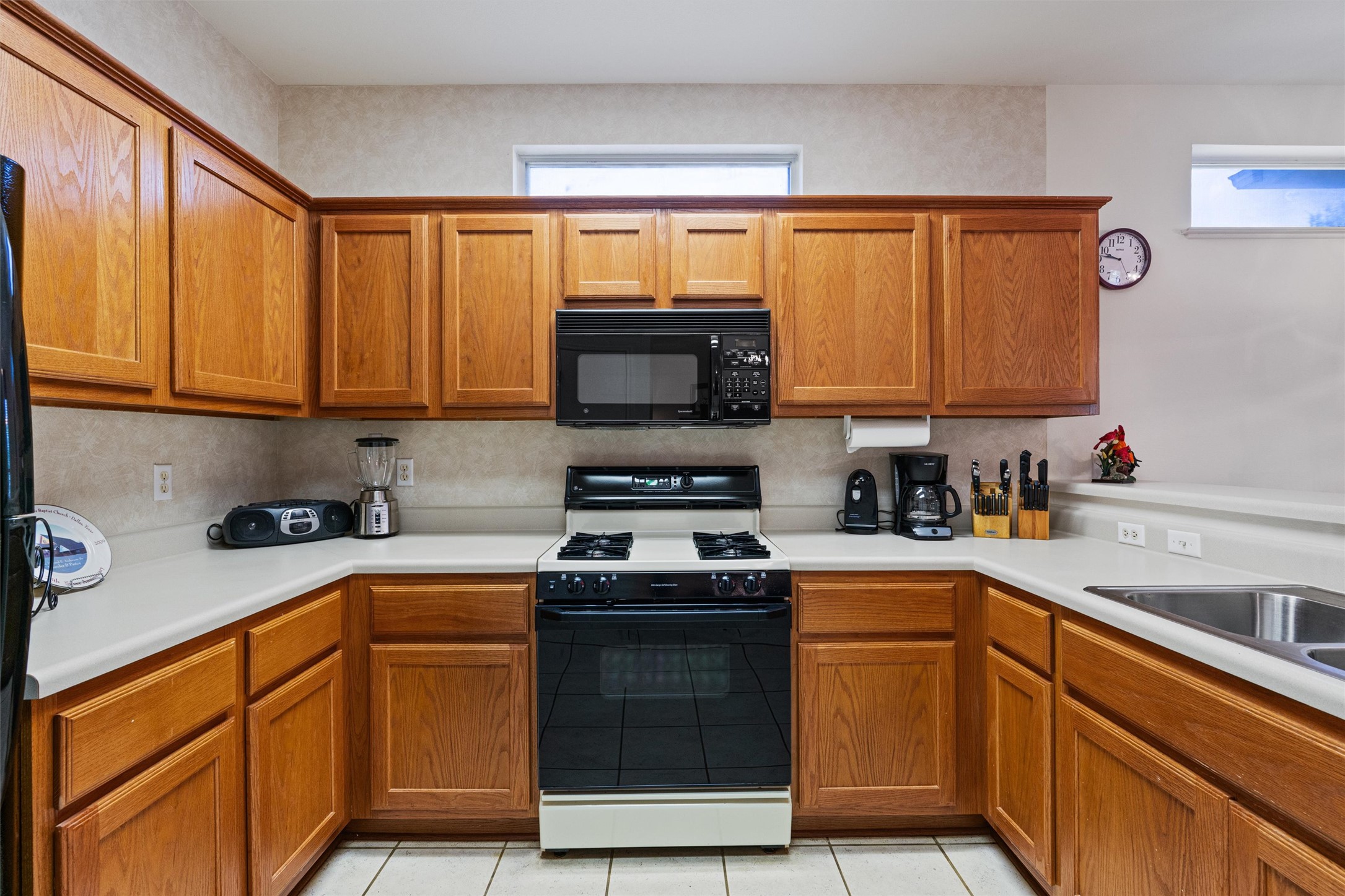 121 Larkspur Lane Georgetown, TX 78633 - Photo 10 of 28 a kitchen with stainless steel appliances granite countertop a stove a sink and a microwave