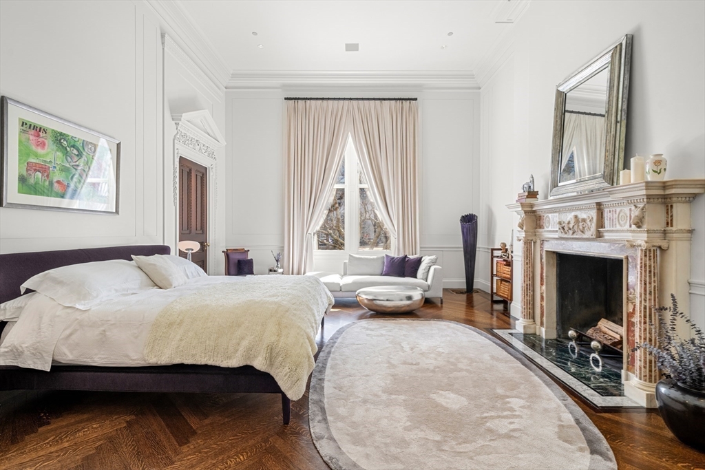 3 Commonwealth Avenue, Unit 1 Boston, MA 02116 - Photo 17 of 30 a bedroom with a bed and a fireplace