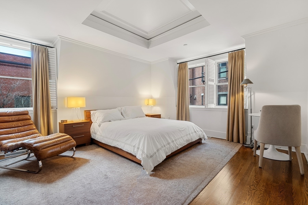 3 Commonwealth Avenue, Unit 1 Boston, MA 02116 - Photo 19 of 30 a bedroom with a bed and large windows