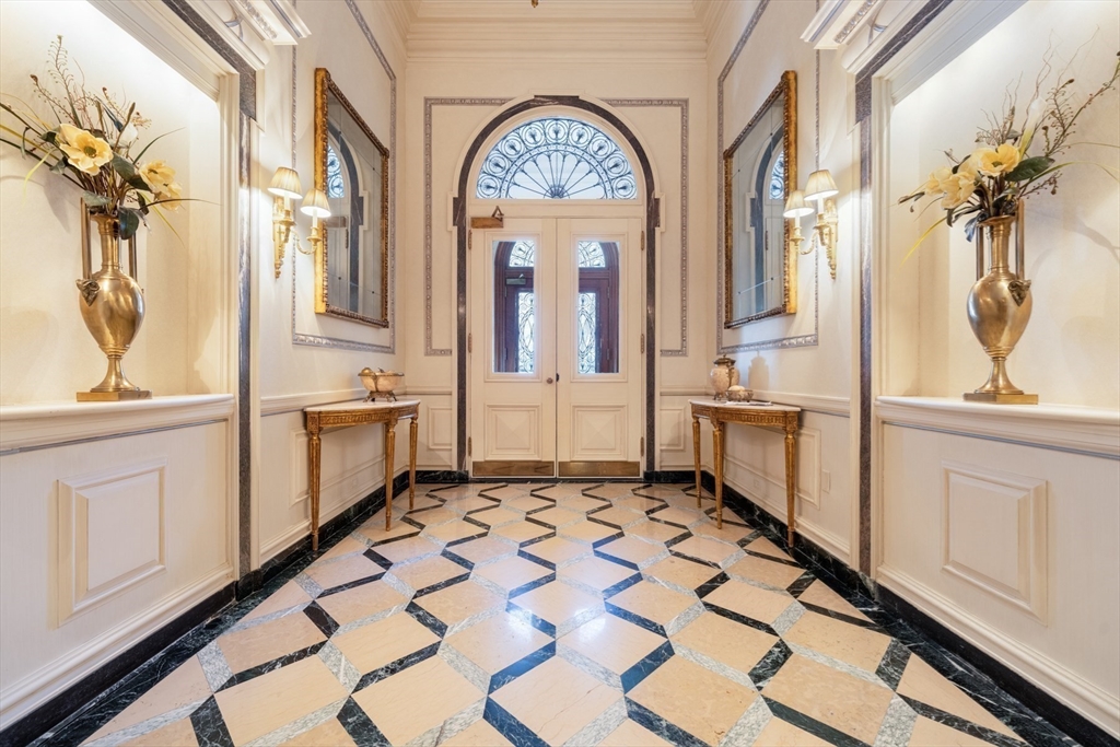 3 Commonwealth Avenue, Unit 1 Boston, MA 02116 - Photo 26 of 30 a large white kitchen with stainless steel appliances a stove a sink and a large window