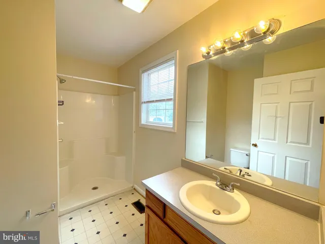 a bathroom with a sink double vanity and a mirror