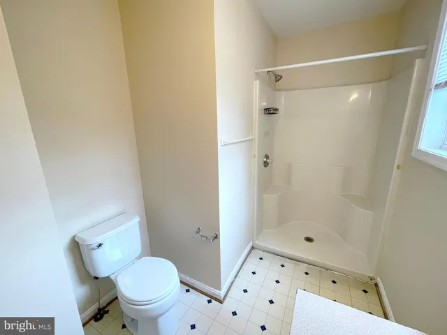 a white toilet sitting next to a bathroom sink