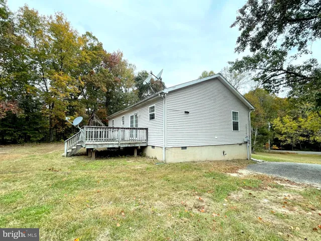 a view of a house with a yard and sitting area