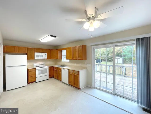 a kitchen with a refrigerator and a stove top oven