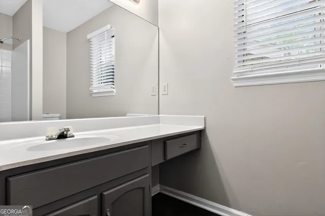 a bathroom with a sink and a window