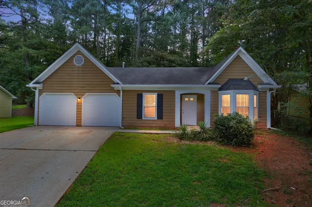 a front view of house with yard and green space