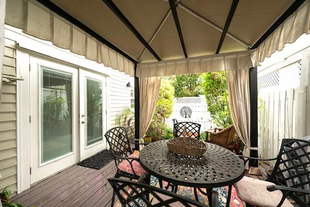 1218 Packer Street, Unit REAR Key West, FL 33040 - Photo 14 of 22 a outdoor dining space with furniture and wooden floor