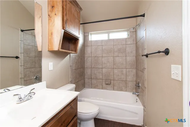 a bathroom with a sink a toilet a bathtub and shower