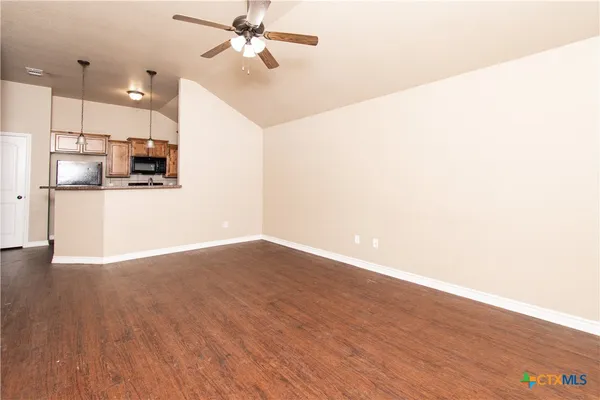 a view of a kitchen with a dishwasher and wooden floor