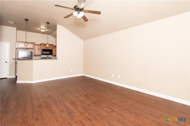 a view of a kitchen with a dishwasher and wooden floor